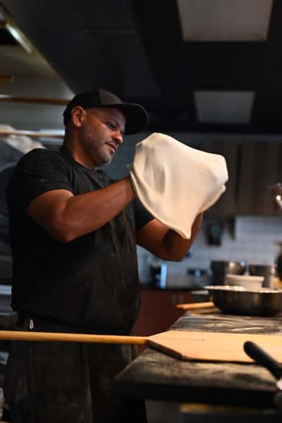 Jose tossing dough