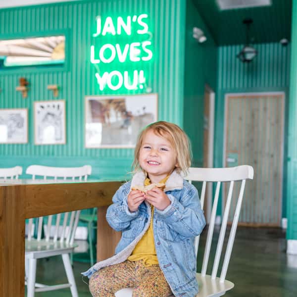 A child enjoying a sandwich at the Jan's Health Bar location in Huntington Beach.