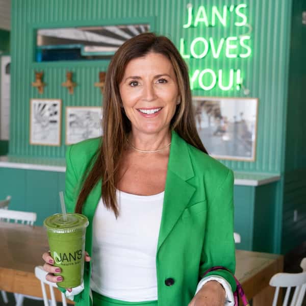 Poppy Holguin holding a Green Machine Smoothie at Jan's Health Bar.
