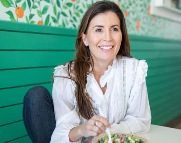 Poppy Holguin, Owner of Jan's Health Bar posing with a Cali Chop Bowl.