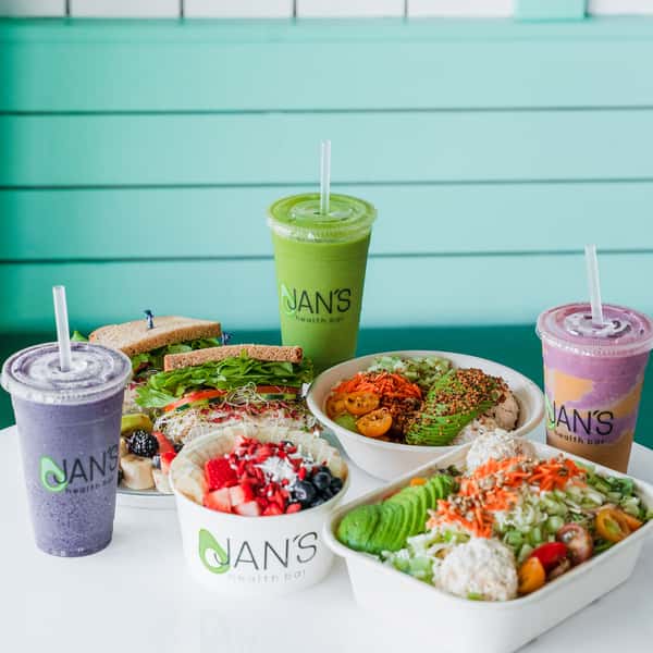 Poppy Holguin, owner of Jan's Health Bar, celebrating owning Jan's Health Bar for 15 years with a Jan's Classic Sandwich and Strawberry Delight smoothie.