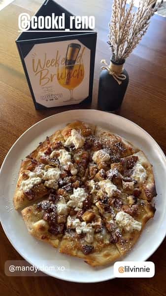 Flatbread pizza topped with crumbled cheese, caramelized onions, and savory toppings