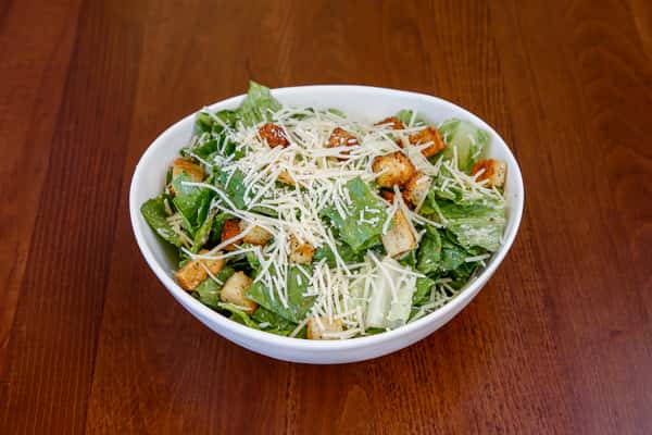 Caesar salad with crisp romaine, Parmesan cheese and creamy dressing