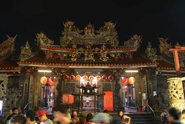 Ornately decorated traditional Taiwanese temple illuminated at night near the Shilin Night Market in Taipei, Taiwan.