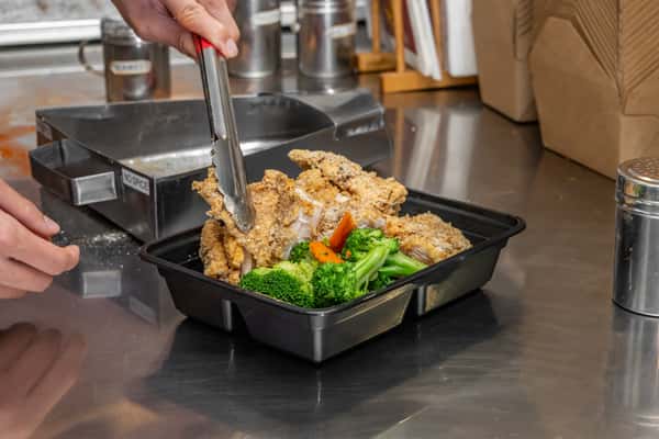 Employee serving chicken