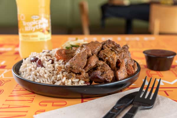 brown stew chicken combo with rice and peas