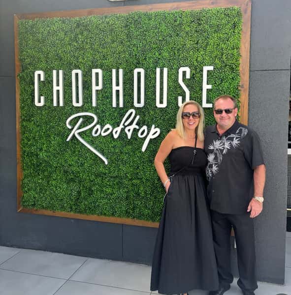 Guests in front of sign
