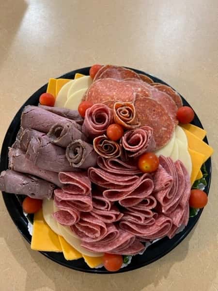 Deli meat and cheese platter with cherry tomatoes