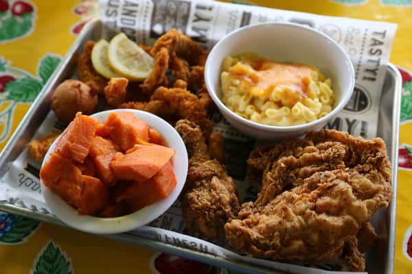This is a photo of our 6th Ave Platter at Southern Kitchen in Tacoma that comes with fried chicken, catfish, candied yams, and macaroni and cheese. 