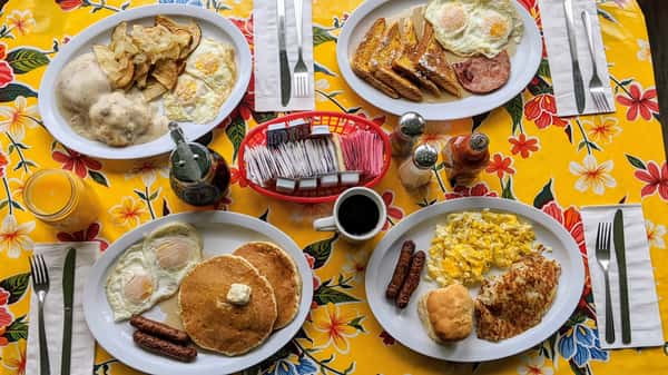 various breakfast food dishes - eggs, pancakes, toast, sausage, ham 