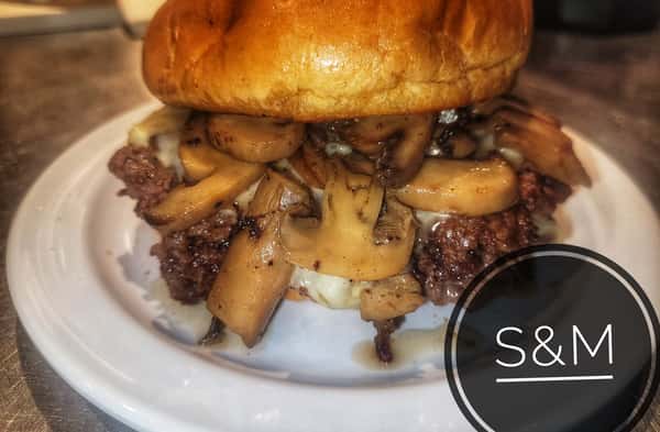 Burger topped with sautéed mushrooms and melted cheese