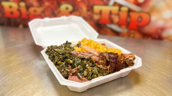 BBQ platter with collard greens, macaroni and cheese, and smoked meat in a styrofoam container.