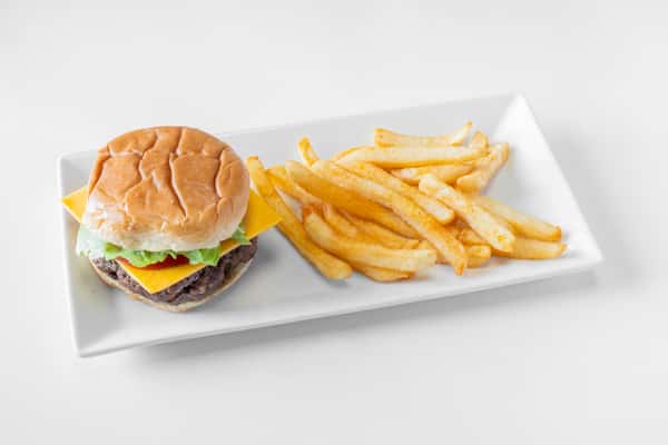 A juicy cheeseburger with toppings served alongside golden french fries on a white plate
