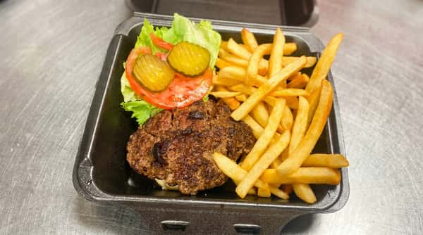 Hamburger patty with lettuce, tomato slices, pickles, and french fries in a black take-out container.