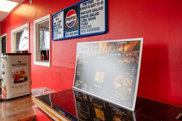 The interior of Smoke T's BBQ restaurant showing the menu signage on the wall