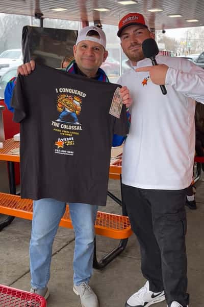 competitor displaying the prized shirt
