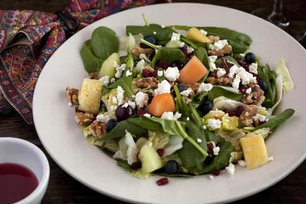 Salad of fresh mixed greens, goat cheese, walnuts, cranberries & mixed fruit