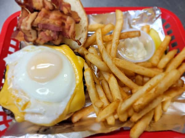 Hangover Burger with melted yellow cheese, fried egg, and bacon