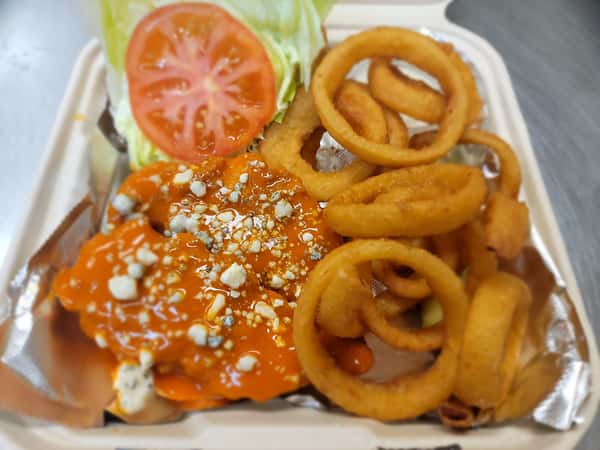A vibrant buffalo chicken sandwich topped with blue cheese, tomato, and lettuce