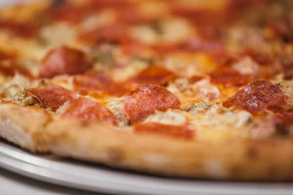 the special pizza with pepperoni, black forest ham, sausage, caramelized onions, mushrooms, olives and cheese
