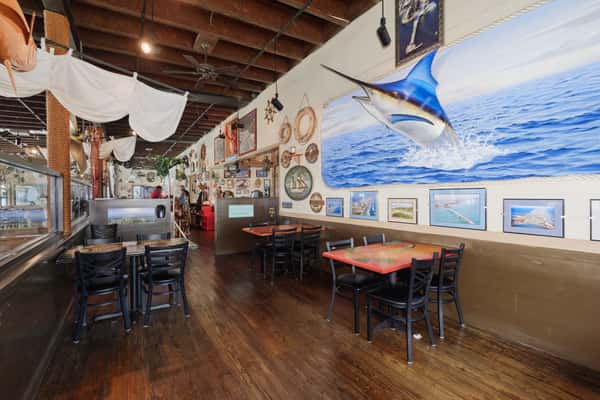 interior seating at restaurant with mural of a Marlin
