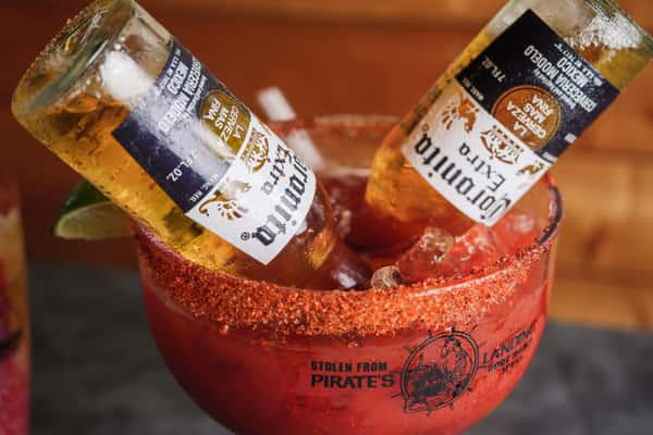 Michelada with two bottles of Corona beer and chili powder rim