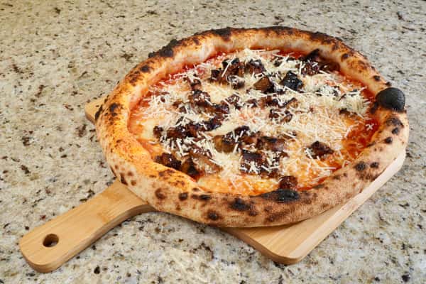 Neapolitan pizza with grilled eggplant and grated parmesan on marble countertop