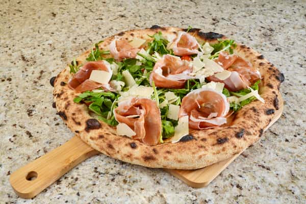 Neapolitan pizza with prosciutto, arugula, and shaved parmesan