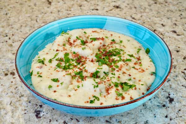 Gnocchi in creamy white sauce topped with herbs and crispy bits