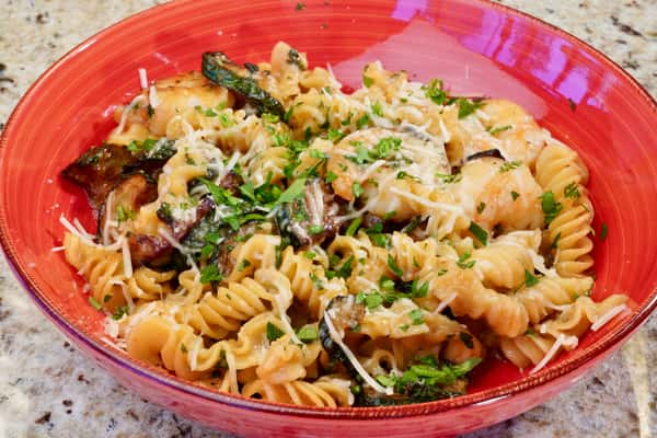 Rotini pasta with eggplant and cheese in a red sauce