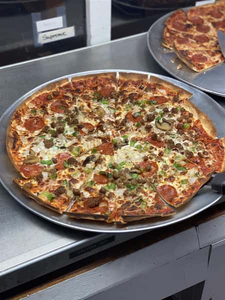 specialty pizza pie with pepperoni, peppers, sausage, onions and mushrooms
