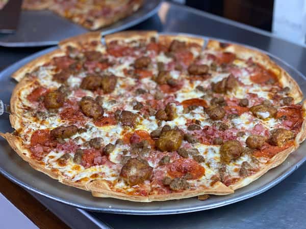 specialty pizza with pepperoni, sausage and ham