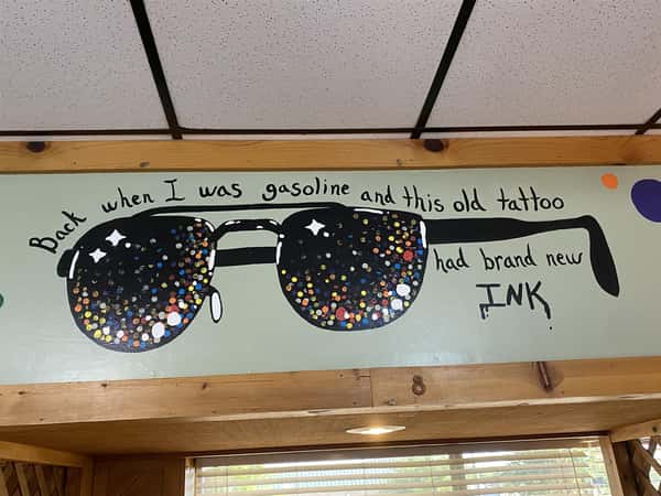 a sign in the restaurant that says "back when i was gasoline and this old tattoo had brand new ink"