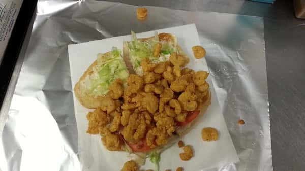Fried shrimp poboy fully dressed with lettuce tomato and mayo
