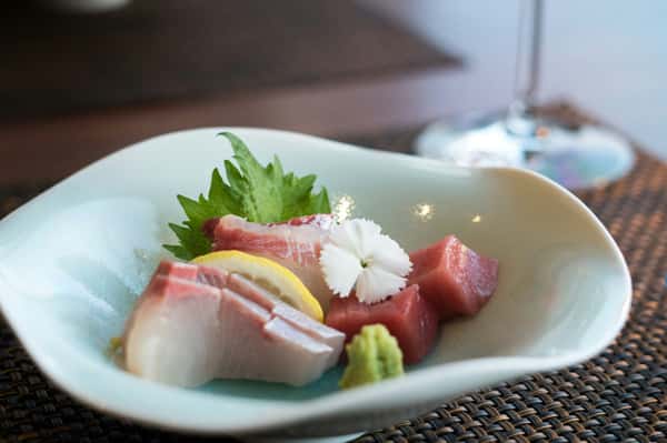 Assorted fresh sashimi served on a white plate at Sumiya restaurant