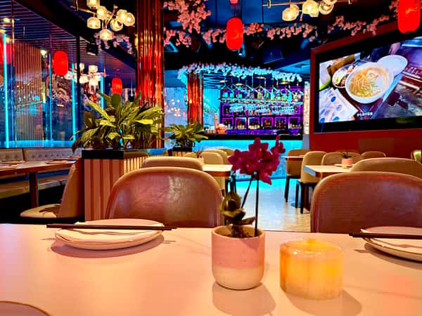 Vibrant interior of Sumiya restaurant with neon lighting and colorful décor