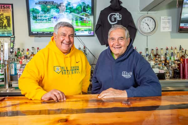 owners standing behind the bar