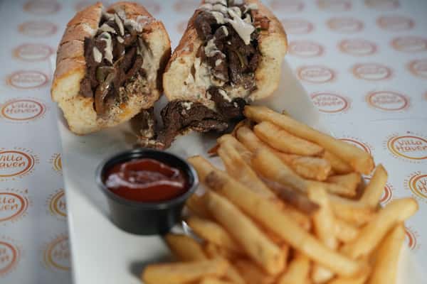 Saucy sandwich with fries