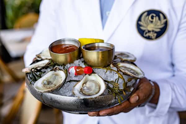 Waiter with a tray of oysters
