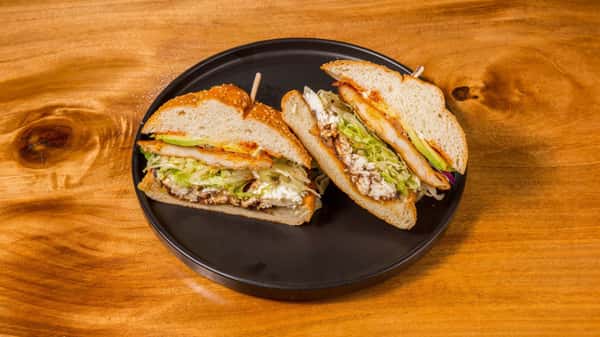 Fresh deli sandwich layered with turkey, vegetables, and cheese.