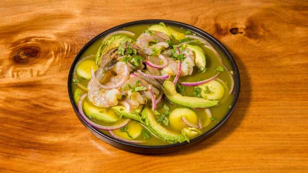 Fresh shrimp ceviche with avocado, cucumber, onions, and lime.
