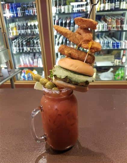 bloody mary topped with mini burger, onion ring, chicken wing and chicken tenders