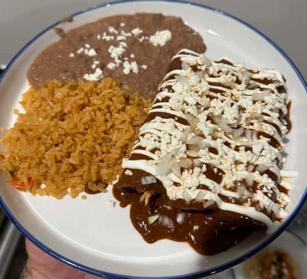 Enmoladas (Rolled Fresh Corn Tortillas Stuffed with Shredded Chicken and Topped with a Rich Mole Sauce)