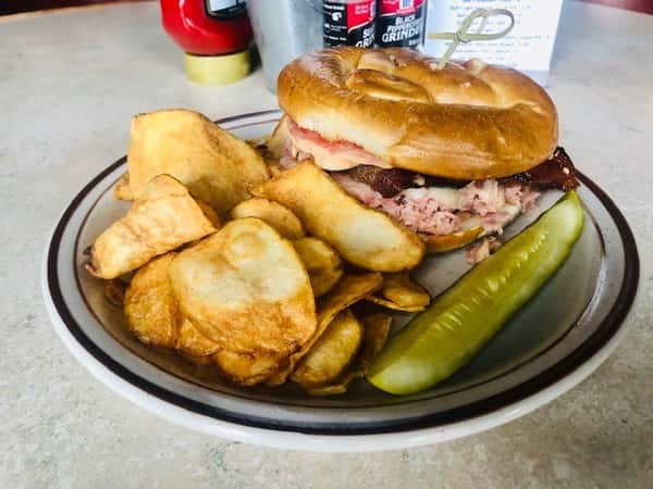 Ham and Cheese Sandwich: Thinly sliced grilled ham, topped with white cheddar, thick slices of bacon, sauteed red onion, and fresh tomato. Everything piled on a pretzel roll with bistro sauce