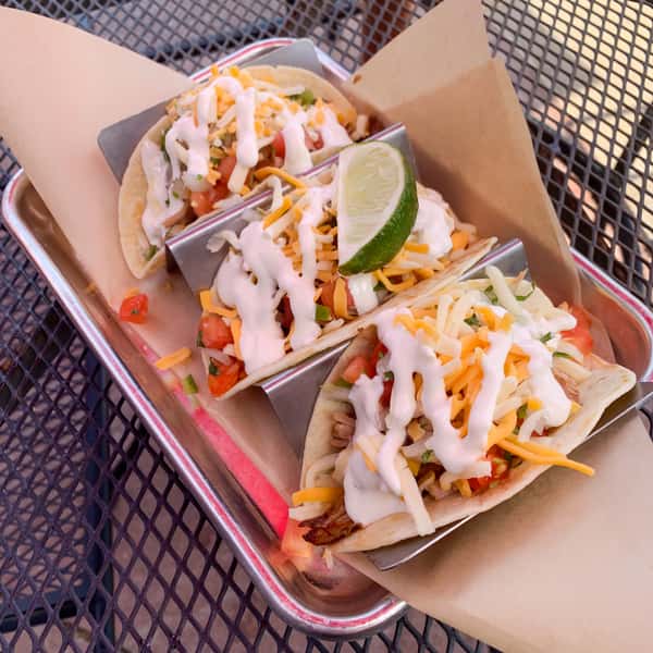 Three Soft Flour Tortillas filled with Roasted Carnitas, Cheese, Pico de Gallo, and Sour Cream