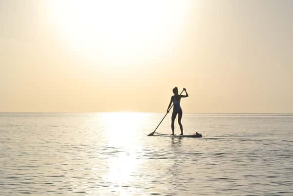 person paddle boarding