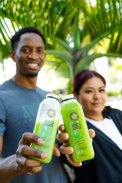 Boy and girl drinking green juice