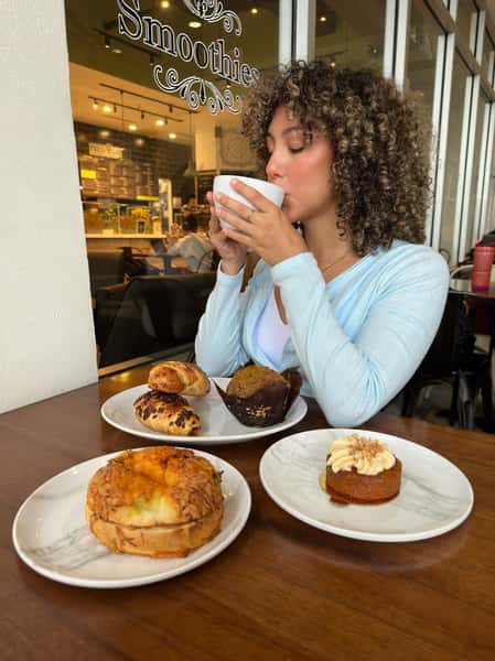 Girl having coffee and some pastries