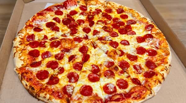Pepperoni and pineapple pizza, sliced into 8 pieces, in a cardboard pizza box.