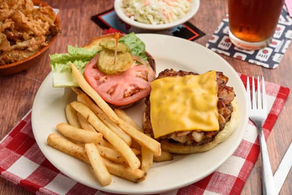 open faced bacon cheeseburger with lettuce,tomato, and pickles with a side of fries